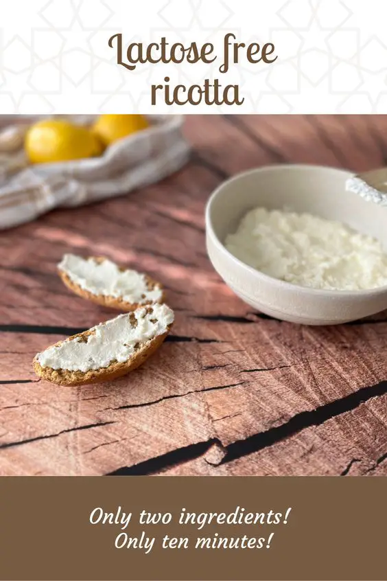 ricotta in a bowl with lemons on the table with bread and ricotta spread on top