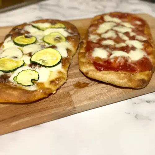 roman pinsa with mozzarella and tomato sauce, second roman pinsa with mozzarella and zucchini