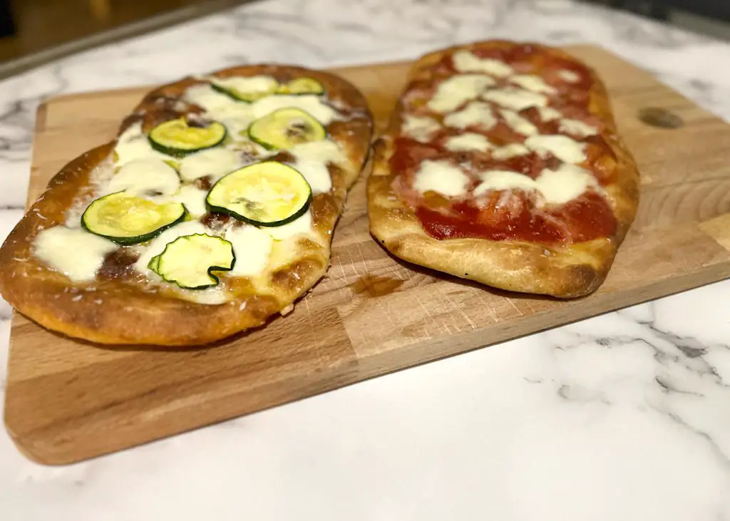 roman pinsa with mozzarella and tomato sauce, second roman pinsa with mozzarella and zucchini